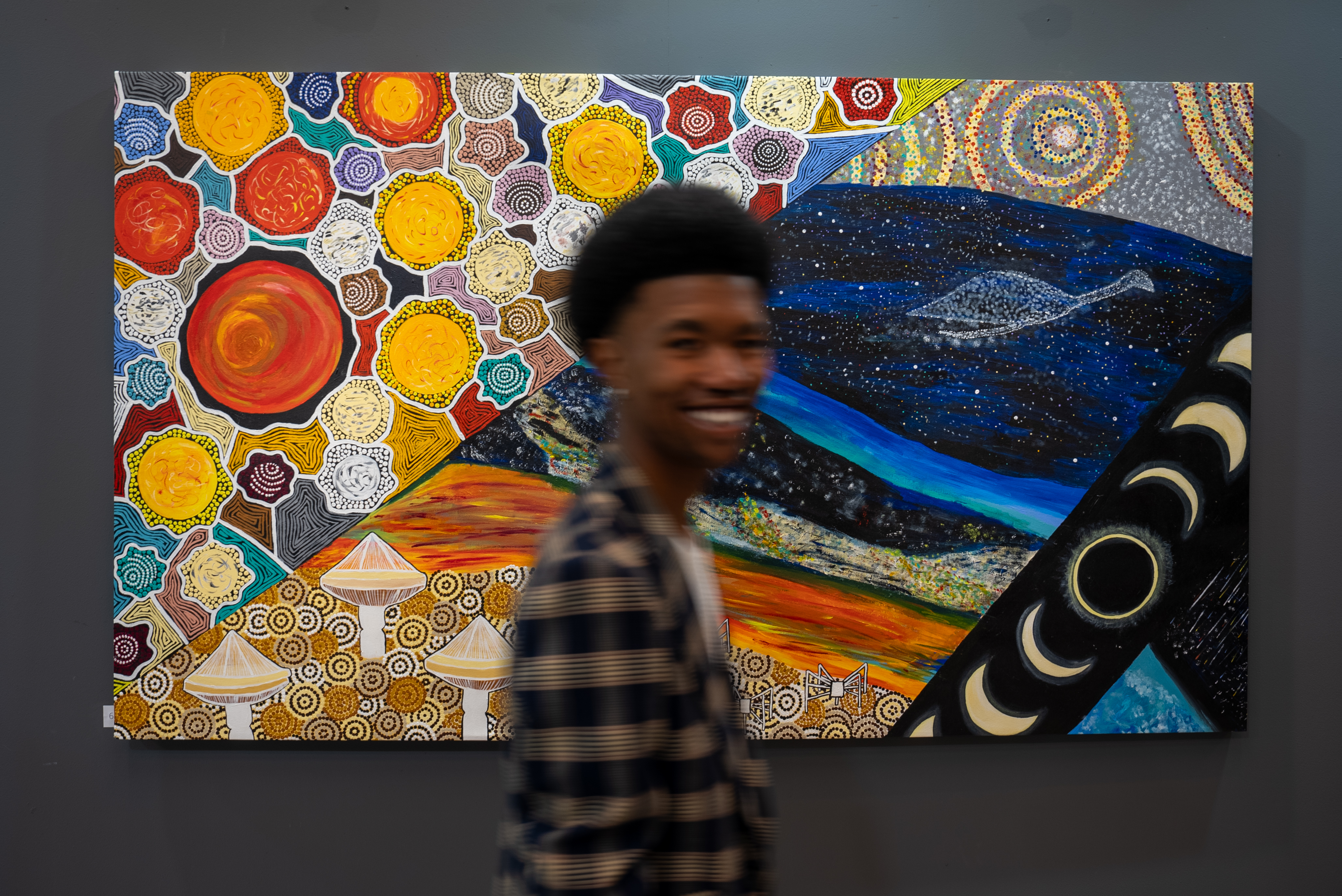 Attendee walking past Cosmic Echo artwork at launch in Cape Town. Artwork featured: Look Out, Gail Rose Simpson