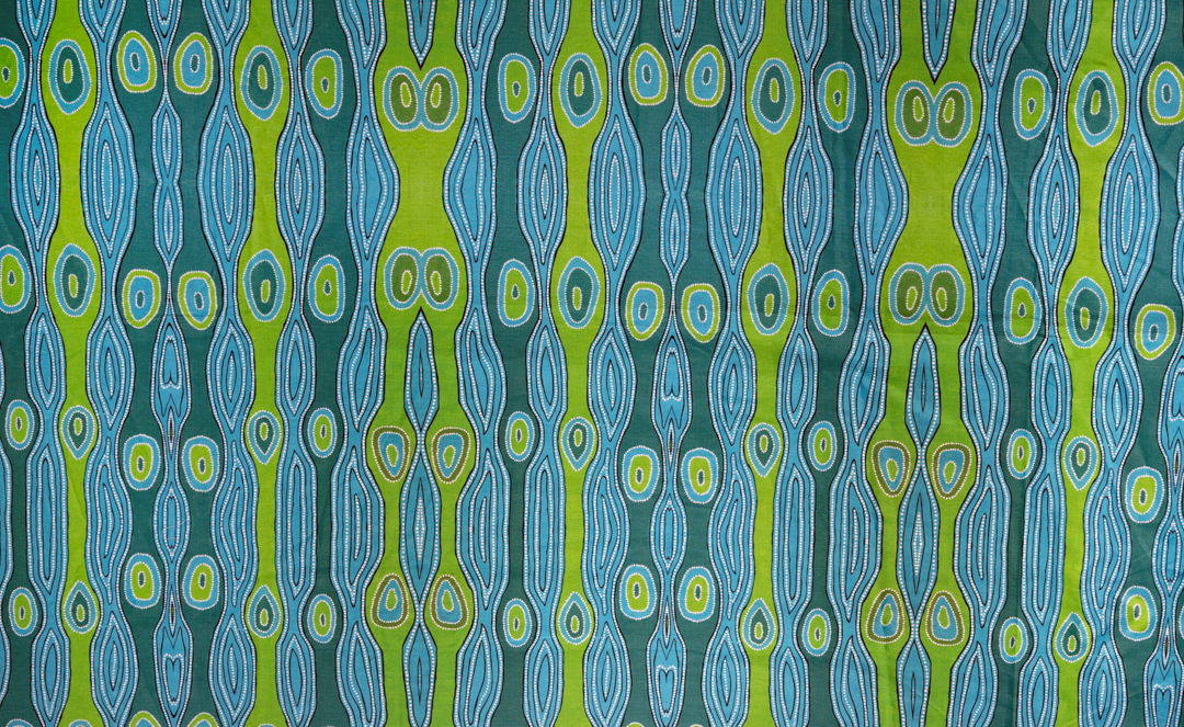 Printed cotton sheet showing egg-shapes in rows and columns in the colours blue and green.