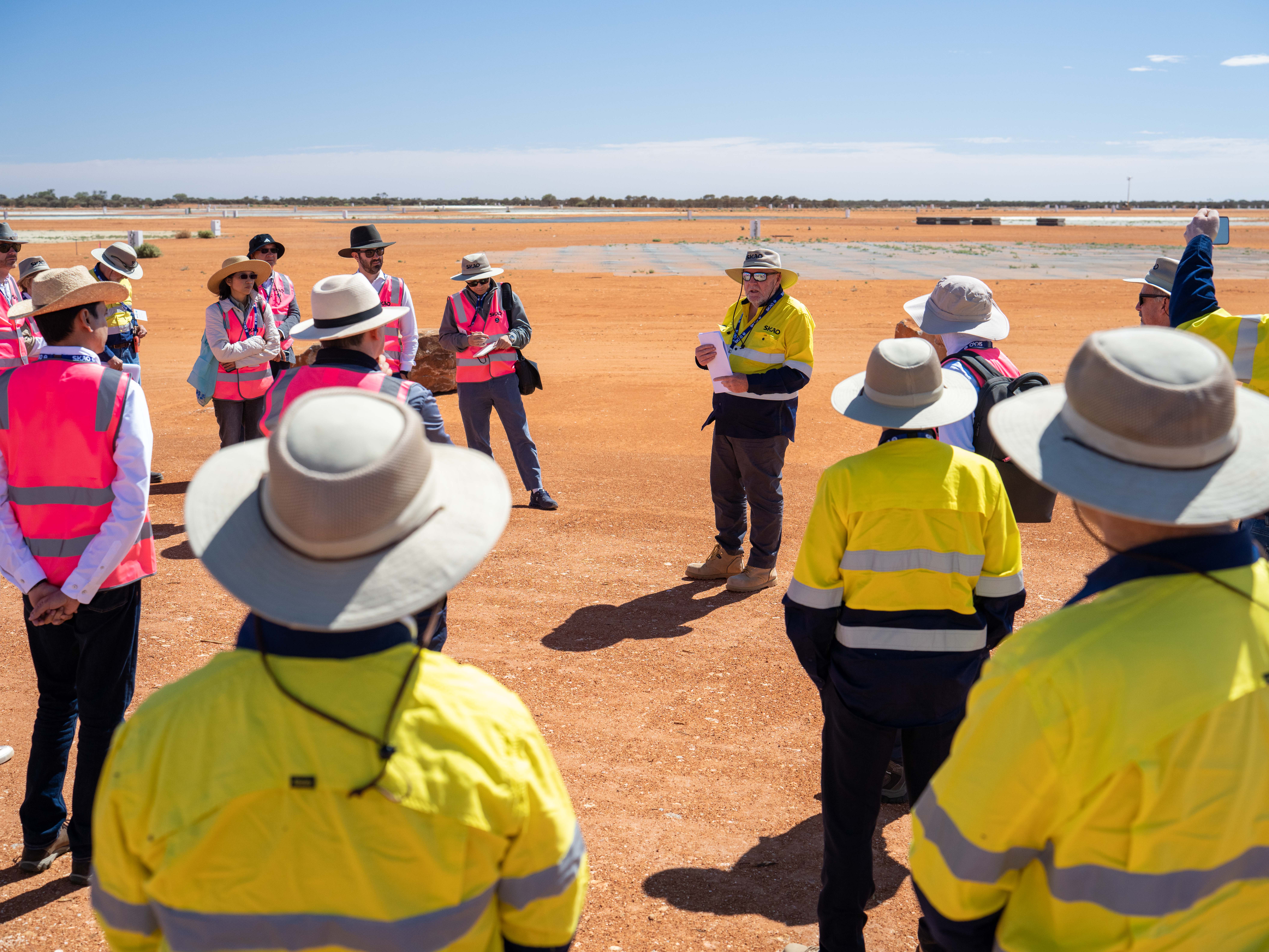 A group of people in hi-vis jackets and vests