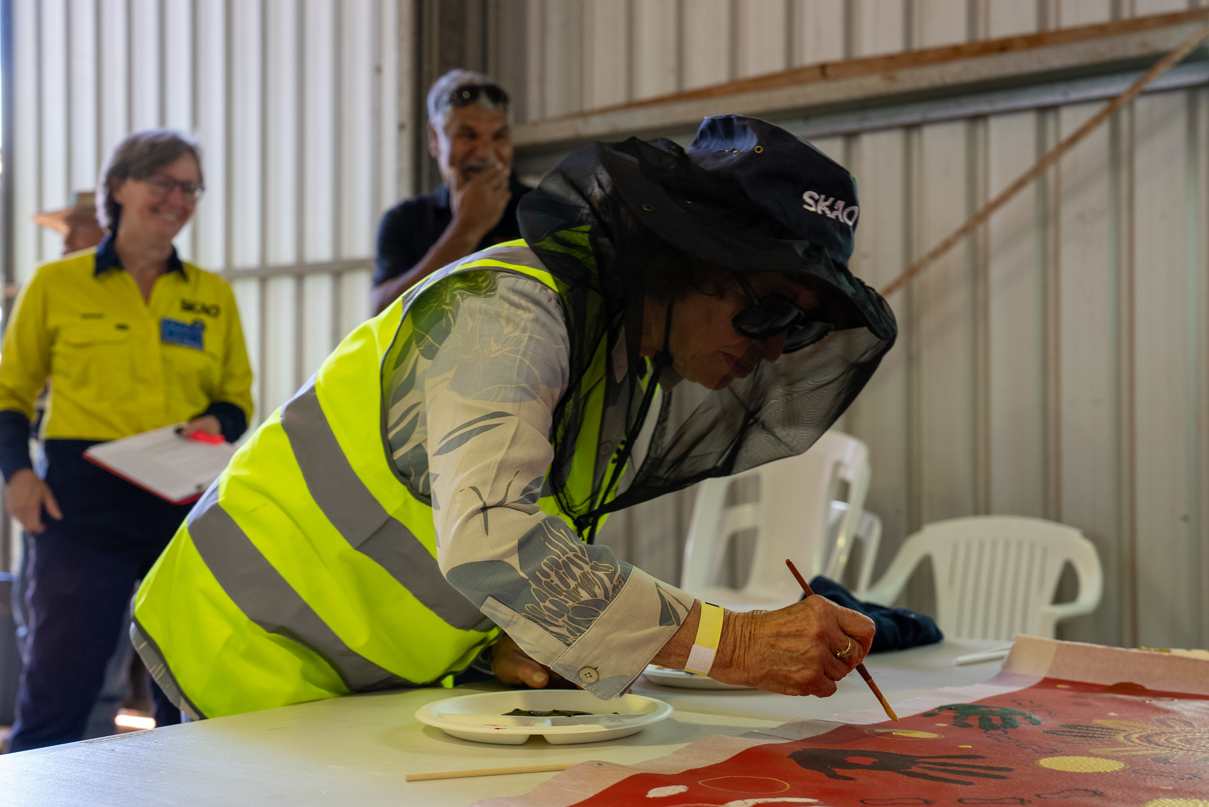 Dr Catherine Cesarsky painting an artwork.