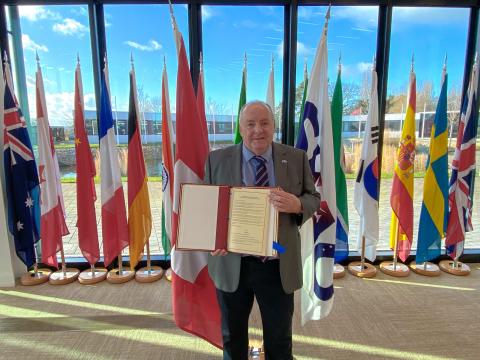 Director-General of the SKA Observatory, Prof. Philip Diamond, holds the SKAO treaty in the organisation’s council chamber.