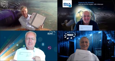 the leaders of CERN, PRACE and Géant smile at the camera holding a signed agreement on Zoom