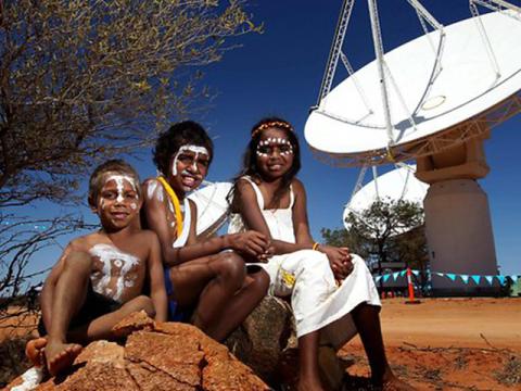 Wajarri children sit near an ASKAP dish during a ceremony at the Murchison Radio astronomy Observatory. Credit: CSIRO