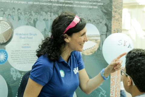 Maria Grazia Labate at an SKA outreach event speaking to a young person.