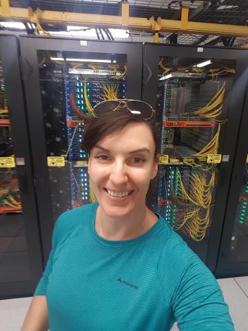 Rebecca Wheadon in front of computing racks