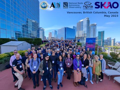 Group photo of the attendees at the SKA-ngVLA science meeting, with the Vancouver skyline in the background