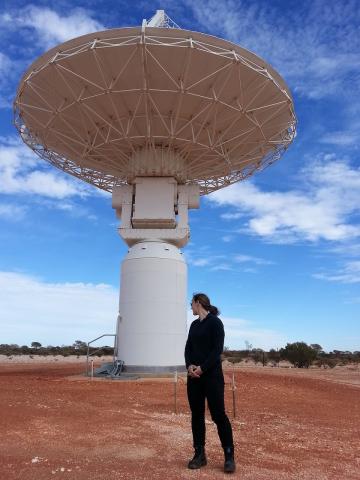 Rebecca Wheadon with an ASKAP antenna