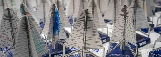 Picture of many paper antenna models close together on a white surface.