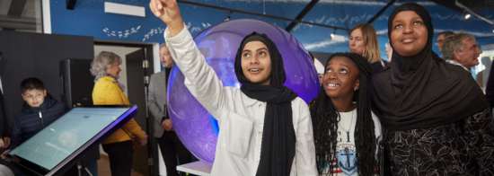 Picture of three young girls at a science visitor centre.
