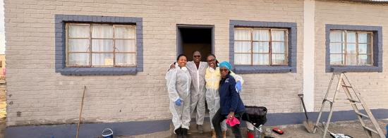 Four employees at the house they are renovating.