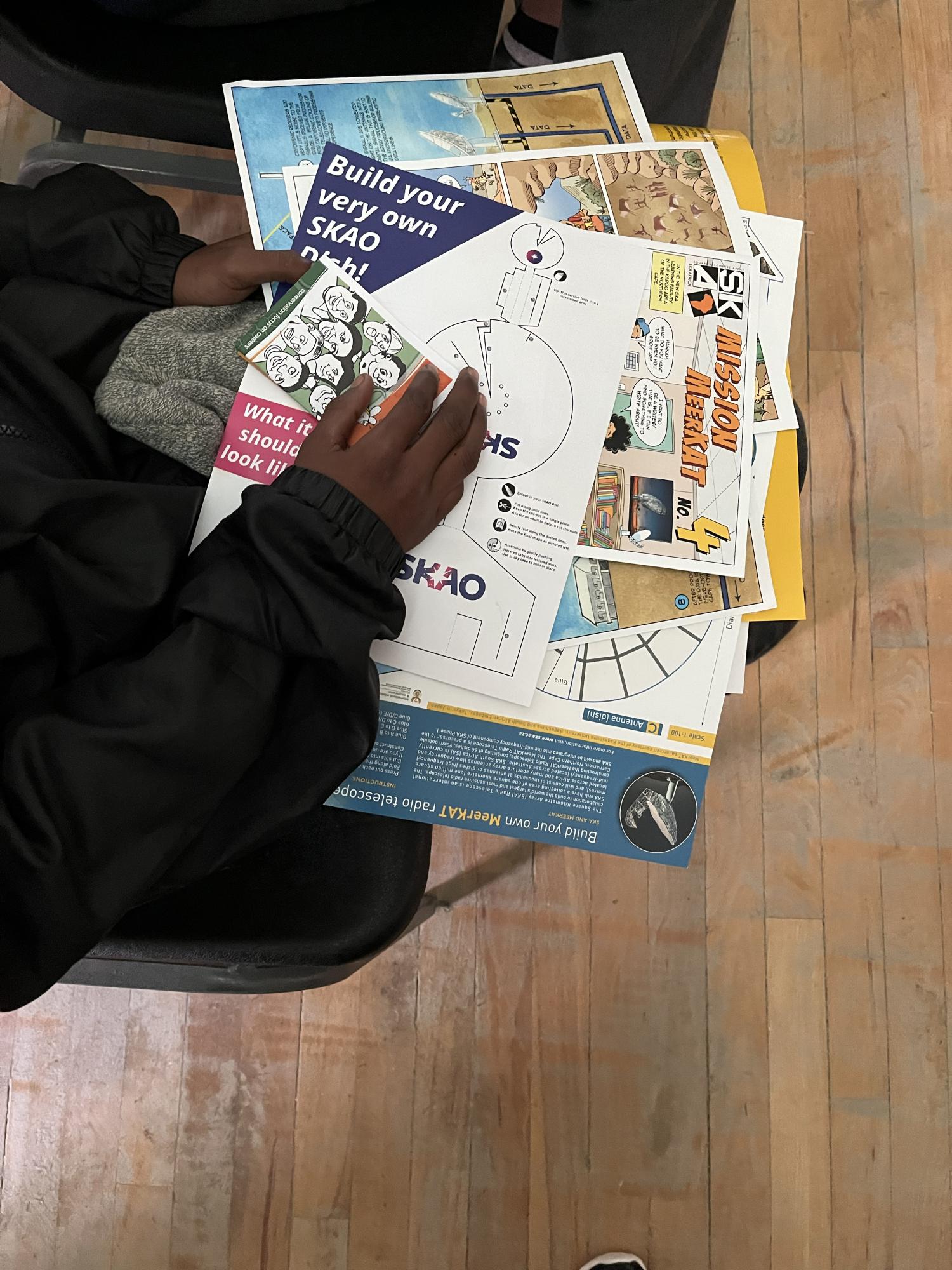 A close up of a child's hand on educational material