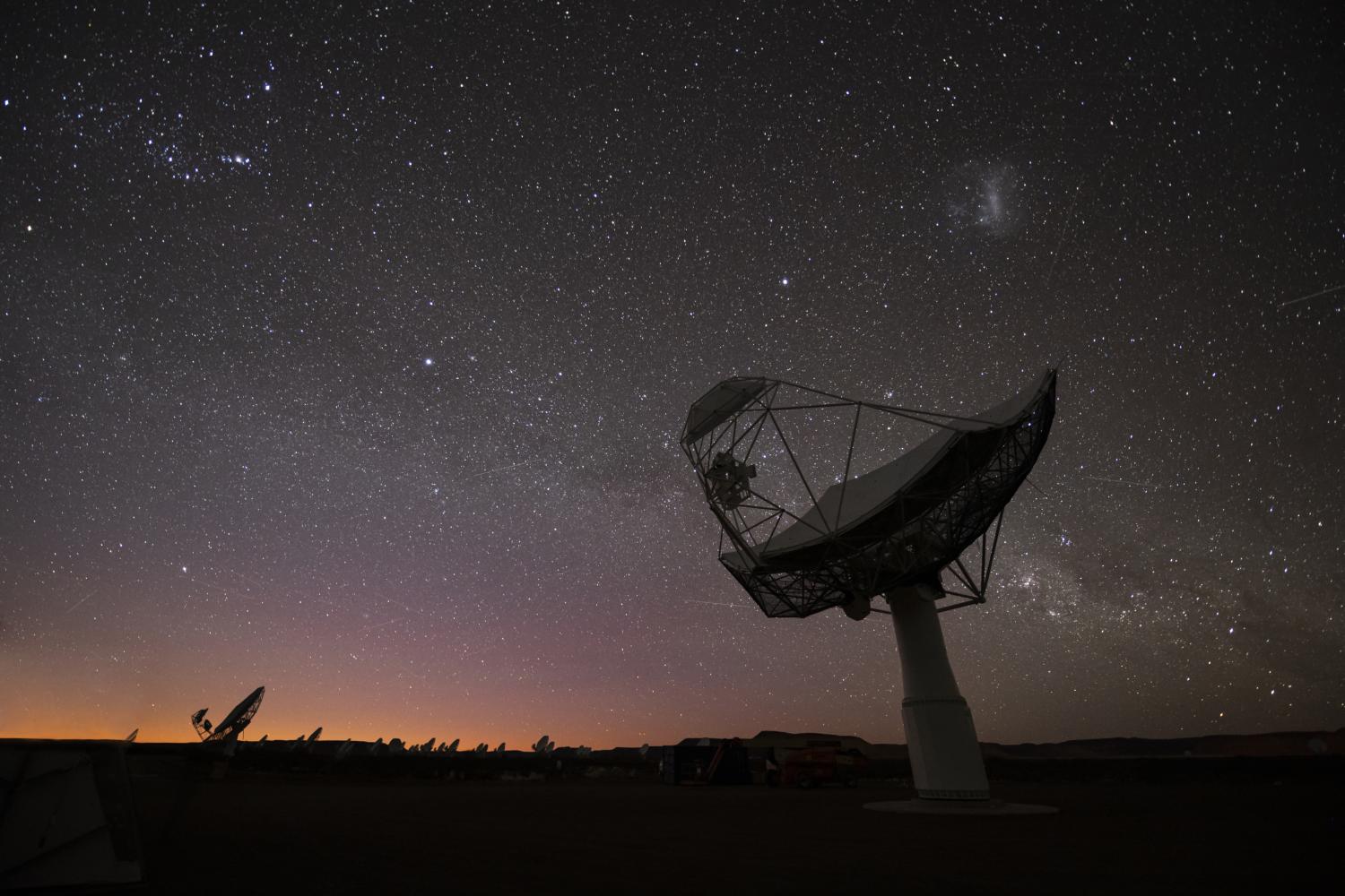 The Mllky Way above the SKA-Mid telescope dishes.