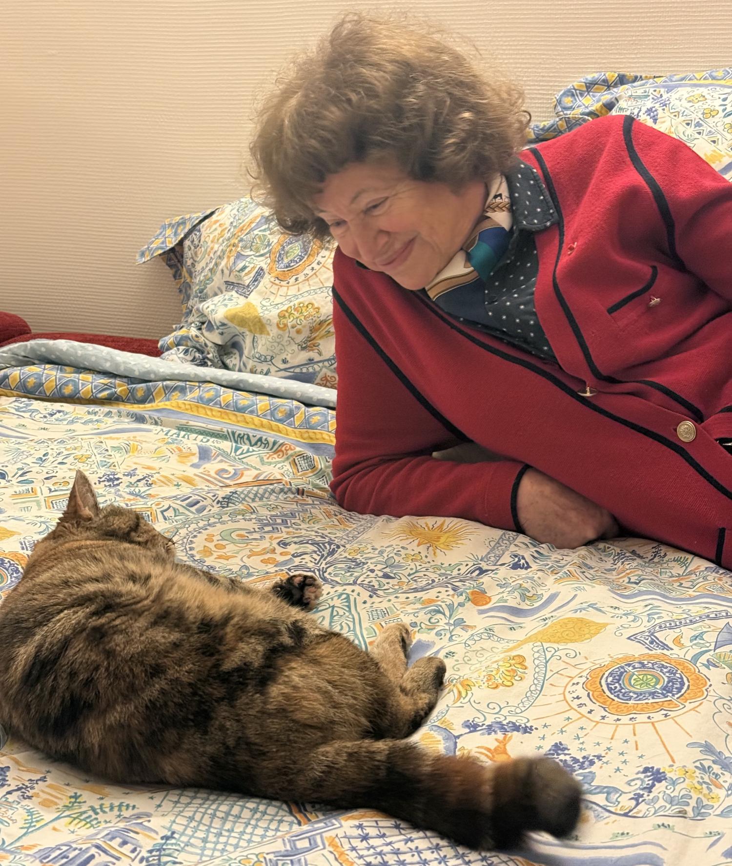 Catherine Cesarsky with her cat, a long-haired dark tabby.