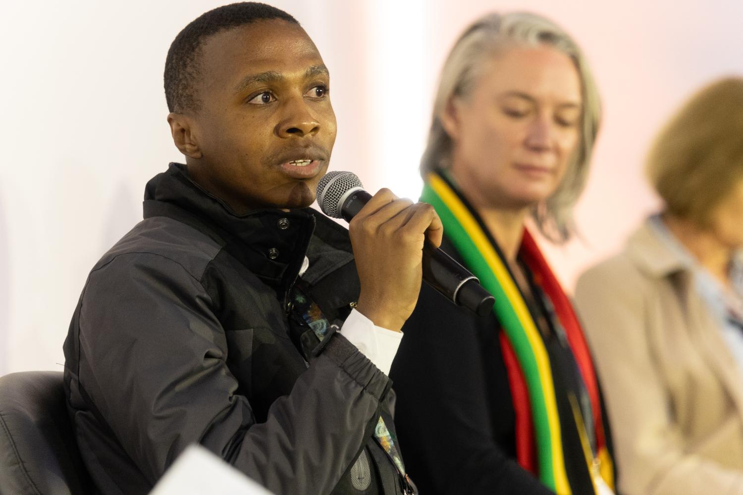 Isaac Magolego next to Prof. Jessica Dempsey at the G20 panel.
