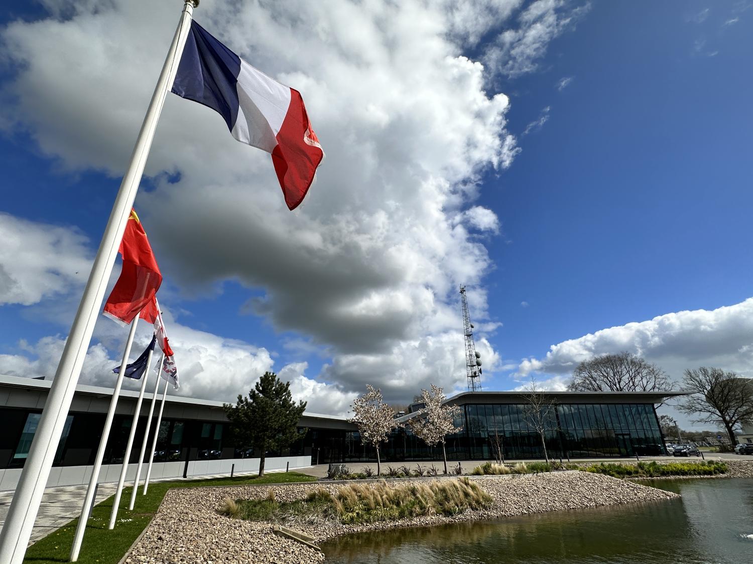 The French flag flying outside SKAO HQ alongside other flags in the background.