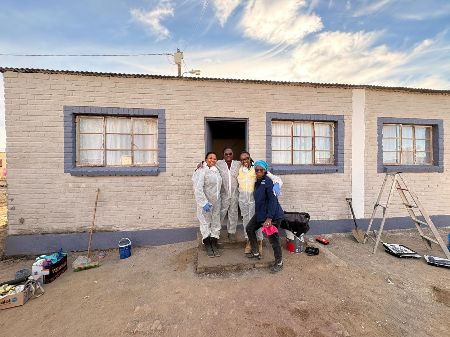 Four employees at the house they are renovating.